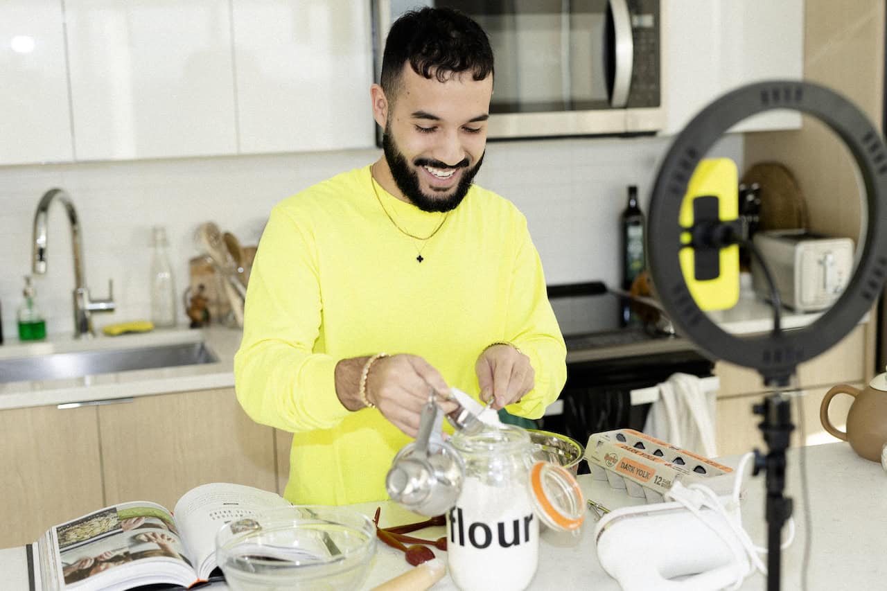 A content creator filming a cooking tutorial that they will sell as a digital product.